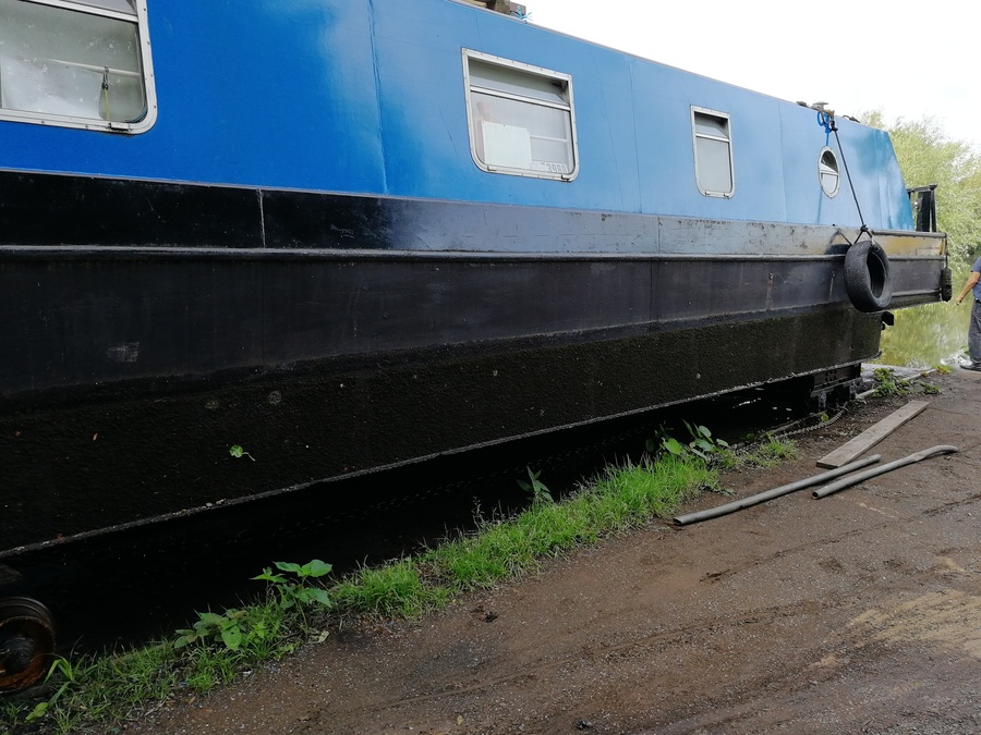 An image of my narrowboat out of the water upon railtracks next to the water