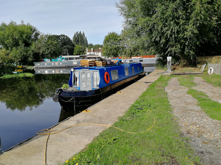 An image of my bright blue narrowboat on a Summer's day